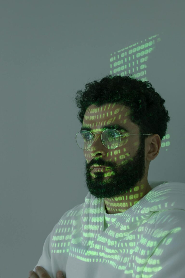 Close-up of a man with digital code projected on his face symbolizing cyber security and technology